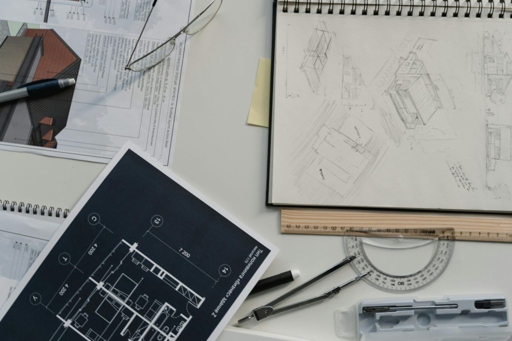Creative workspace with architectural sketches, blueprints, and drawing tools, perfect for planning and design.
